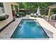 Backyard pool, surrounded by a patio and greenery and is great for lounging and entertaining on sunny days at 1701 Dearmon Dr, Charlotte, NC 28205