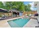 Inviting backyard pool featuring lounge chairs, privacy fence and lush landscaping at 1701 Dearmon Dr, Charlotte, NC 28205