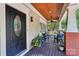 Inviting front porch with comfortable seating, a ceiling fan, and stylish decor at 1701 Dearmon Dr, Charlotte, NC 28205