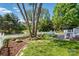 Backyard with stone benches and a well maintained lawn and a white picket fence at 17130 Bridgeton Ln, Huntersville, NC 28078