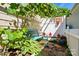 Secluded backyard seating area surrounded by lush greenery, plants and a small decorative table at 17130 Bridgeton Ln, Huntersville, NC 28078
