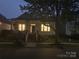 Charming home with a front porch and illuminated windows at dusk at 17130 Bridgeton Ln, Huntersville, NC 28078