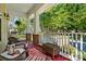 Inviting front porch with comfortable wicker seating and views of a lush, tree-lined street at 17130 Bridgeton Ln, Huntersville, NC 28078
