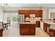 Spacious kitchen features stainless steel appliances, center island, tile floor, and plenty of cabinet space at 17130 Bridgeton Ln, Huntersville, NC 28078