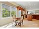 Sun-filled breakfast nook adjacent to kitchen with large windows offering lovely view of mature trees at 17130 Bridgeton Ln, Huntersville, NC 28078