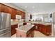 Open-concept kitchen with stainless steel appliances, tile backsplash, kitchen island, and view to the living room at 17130 Bridgeton Ln, Huntersville, NC 28078