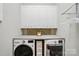 Bright laundry room with modern washer and dryer and ample counter space at 17130 Bridgeton Ln, Huntersville, NC 28078
