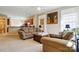 Inviting living room featuring neutral tones, ceiling fan, and an open layout flowing into the kitchen at 17130 Bridgeton Ln, Huntersville, NC 28078
