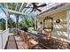 Inviting outdoor dining area with a pergola, ceiling fan and comfortable seating at 17130 Bridgeton Ln, Huntersville, NC 28078