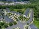 Aerial view of townhomes and a pond in a suburban neighborhood at 1769 Evergreen Dr, Charlotte, NC 28208