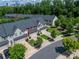 Aerial view of townhomes with manicured lawns, mature trees, and Charlotte city skyline in the background at 1769 Evergreen Dr, Charlotte, NC 28208