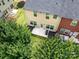 Aerial view of a backyard and home with a patio and grill surrounded by green grass at 1769 Evergreen Dr, Charlotte, NC 28208