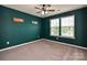 Bedroom with two windows, a ceiling fan, neutral carpet and green accent wall at 1769 Evergreen Dr, Charlotte, NC 28208