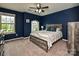 Stylish bedroom with a serene atmosphere, a ceiling fan, and a large window providing natural light at 1769 Evergreen Dr, Charlotte, NC 28208