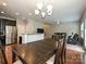 Open-concept dining room with dark wood floors, table, kitchen and living room views at 1769 Evergreen Dr, Charlotte, NC 28208