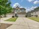 Inviting townhome featuring a two-car garage, blue front door, and well-kept lawn in a residential community at 1769 Evergreen Dr, Charlotte, NC 28208