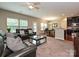 Open-concept living room with plush seating, opening to the dining area and modern kitchen at 1769 Evergreen Dr, Charlotte, NC 28208