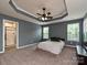 Spacious main bedroom with a tray ceiling, ceiling fan, and ensuite bathroom at 1769 Evergreen Dr, Charlotte, NC 28208
