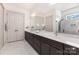 Bathroom boasts a double vanity, a large mirror, and marble flooring at 19031 Brandon James Dr, Cornelius, NC 28031