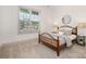 Cozy bedroom featuring neutral tones, a wooden bed frame, and natural lighting at 19031 Brandon James Dr, Cornelius, NC 28031