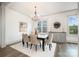Elegant dining room featuring a chandelier, neutral decor, and view from the window at 19031 Brandon James Dr, Cornelius, NC 28031