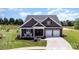 Beautiful home boasts a manicured lawn, cozy rocking chair front porch, and a convenient two-car garage at 19031 Brandon James Dr, Cornelius, NC 28031