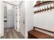 Hallway with wooden floors, coat rack, and view into the kitchen at 19031 Brandon James Dr, Cornelius, NC 28031