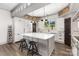 Bright, modern kitchen with white cabinets, island with seating, and contemporary lighting at 19031 Brandon James Dr, Cornelius, NC 28031