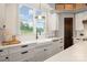 Farmhouse sink under a window with a view in this bright, modern kitchen at 19031 Brandon James Dr, Cornelius, NC 28031