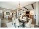 Open-concept living space with wood beams, modern light fixture, and a fireplace at 19031 Brandon James Dr, Cornelius, NC 28031
