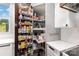 Walk-in pantry with adjustable shelving and pull-out drawers for organized storage at 19031 Brandon James Dr, Cornelius, NC 28031