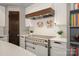 Close-up of range and hood with white subway tile backsplash in this modern kitchen at 19031 Brandon James Dr, Cornelius, NC 28031