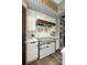 Close-up of range and hood with white subway tile backsplash in this modern kitchen at 19031 Brandon James Dr, Cornelius, NC 28031