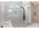 Luxurious walk-in shower with marble tiles, a rain shower head, and a built-in bench at 19031 Brandon James Dr, Cornelius, NC 28031