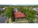 Aerial view of the community tennis court surrounded by mature trees and green landscaping at 19031 Brandon James Dr, Cornelius, NC 28031