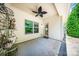 Covered back porch with a ceiling fan, offering a view of the backyard, with a decorative plant stand at 204 Aztec Cir, Mooresville, NC 28117
