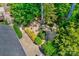 Overhead shot of a landscaped backyard with lush greenery, steps, and a home nestled in trees at 204 Aztec Cir, Mooresville, NC 28117