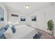 Bright bedroom with white walls and carpet, adorned with a mountain print and a comfortable blue bed set at 204 Aztec Cir, Mooresville, NC 28117