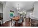 Charming dining room features hardwood floors and an elegant chandelier at 204 Aztec Cir, Mooresville, NC 28117
