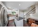 Kitchen features stainless appliances, an island, and access to the stairway at 204 Aztec Cir, Mooresville, NC 28117