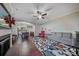 Inviting living room with hardwood floors, a ceiling fan, fireplace, and a seamless flow to the dining area at 204 Aztec Cir, Mooresville, NC 28117