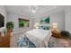 Serene main bedroom featuring a tray ceiling, plush carpet, and a large window for ample natural light at 204 Aztec Cir, Mooresville, NC 28117