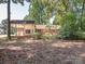 Spacious backyard with a covered patio, mature trees, and lush greenery, perfect for outdoor enjoyment at 2222 Hearthstone Dr, Gastonia, NC 28056