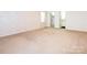 Spacious bedroom with en-suite bathroom featuring neutral wallpaper and plush carpeting at 2222 Hearthstone Dr, Gastonia, NC 28056