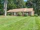 Well-maintained single-story brick home with a manicured front lawn and mature landscaping at 2222 Hearthstone Dr, Gastonia, NC 28056