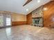 Living room with stone fireplace and door leading outside at 2222 Hearthstone Dr, Gastonia, NC 28056