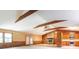 Open floor plan featuring a stone fireplace, wood trim, and cabinetry in the living room at 2222 Hearthstone Dr, Gastonia, NC 28056