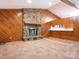 Spacious living room showcasing a stone fireplace and wood paneling at 2222 Hearthstone Dr, Gastonia, NC 28056