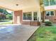 Covered patio featuring brick accents, providing an ideal spot for relaxation and entertaining at 2222 Hearthstone Dr, Gastonia, NC 28056