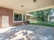 Covered patio with brick accents, offering a versatile outdoor living space and access to the backyard at 2222 Hearthstone Dr, Gastonia, NC 28056